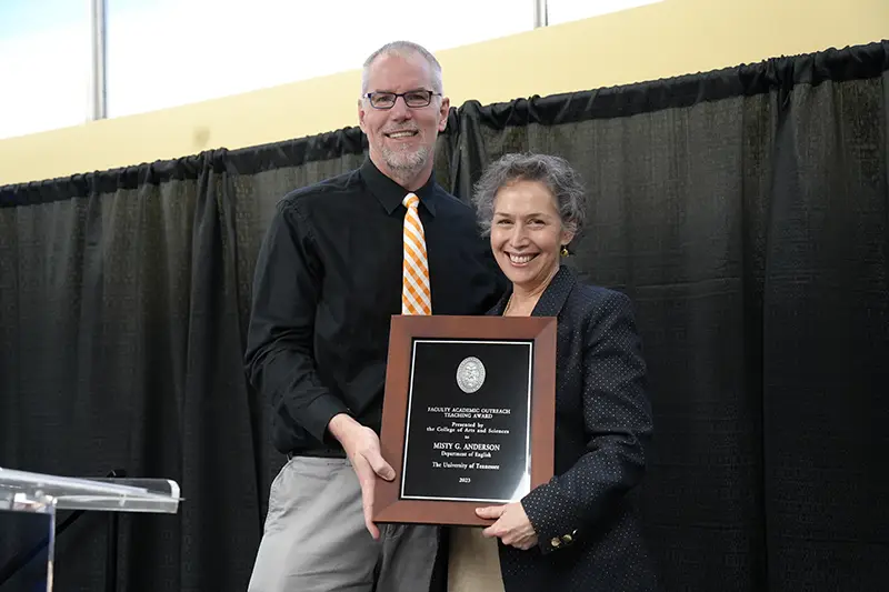 Misty Anderson is presented an award by Todd Moore at the Faculty Awards Ceremony