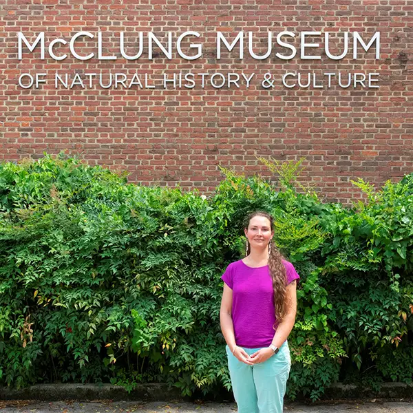 A woman standing in front of the McClung Museum