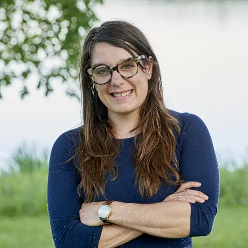 headshot photo of a woman in a blue shirt